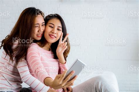 Two Young Asian Women Friend Or Lesbian Couple Taking Selfie With