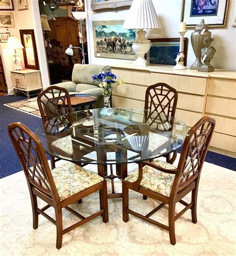 Both the chairs and the dining table rest on chrome metal frames. Beautiful Wood Dining Table Set: Wood Base Table with Round Glass Top, and Four Wood Fra ...