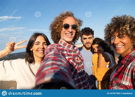 Group Of Multiracial Friends Take Selfie Having Fun Outdoors Looking At