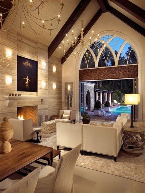 A high ceiling carries fans and chandeliers that offer a. High cathedral ceiling and an arched window (via ...