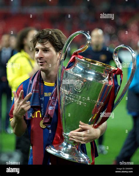 Barcelonas Lionel Messi Celebrates With The Champions League Trophy