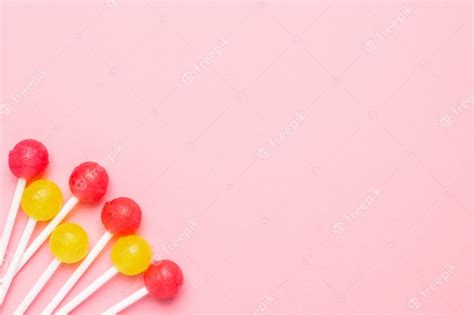 Premium Photo Pastel Pink With Sweet Pink And Yellow Candies Lollipop