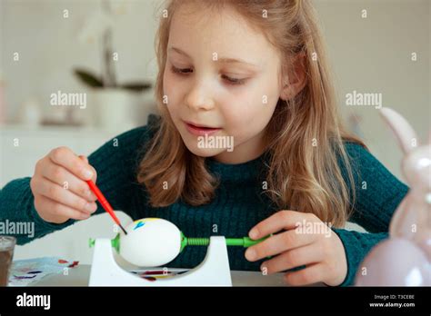 Cute Little Blonde Girl Painting Easter Eggs At Home Stock Photo Alamy