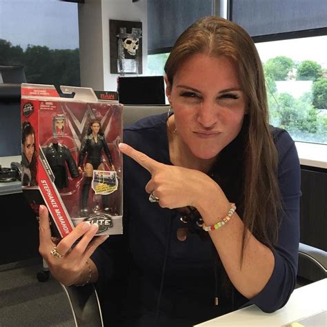 A Woman Sitting At A Desk Holding Up A Box With An Image Of The X Men
