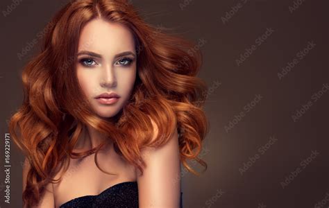 Beautiful Model Girl With Long Red Curly Hair Red Head Care Products Hair Colouring Stock