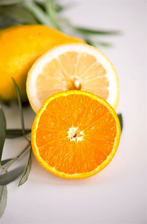 Sliced Orange Fruit On White Surface Photo Free Citrus Fruit Image On