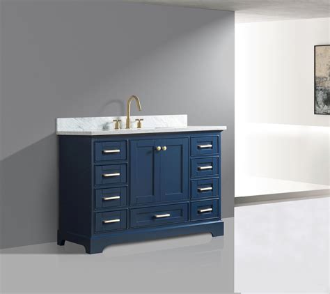 Elegant bathroom with sink vanity and alcove bathtub beneath a charming stained glass window lined with a white column. 48" Single Sink Bathroom Vanity in Blue Finish with ...