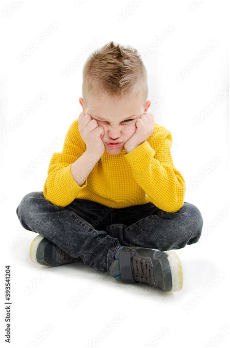 Sulky Angry Young Boy Child Sulking And Pouting Isolated On White