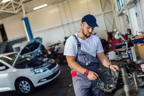 Technician Working On Checking And Service Car In Workshop Garage