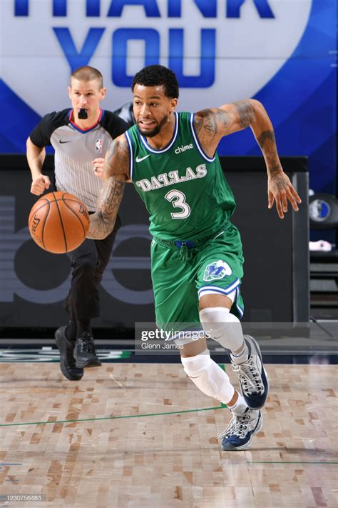 Trey Burke Of The Dallas Mavericks Dribbles The Ball During The Game