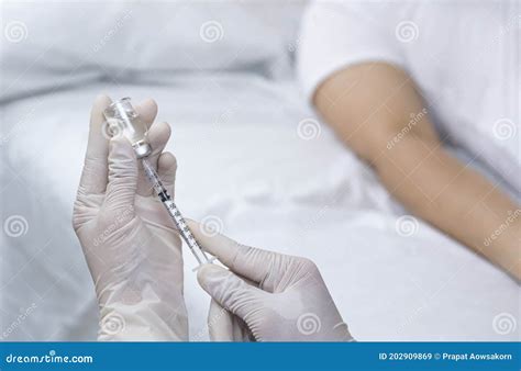 Doctor S Hand Holding Draw Syringe With Vial For Injection Into Patient