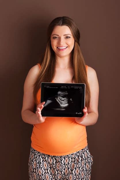 Free Photo Beautiful Pregnant Woman Showing Ultrasound Scan On