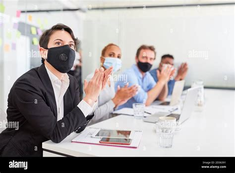 Group Of Business People With Face Masks Because Of Covid 19 Applauds