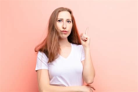 premium photo yound blonde woman covering face with hands peeking between fingers