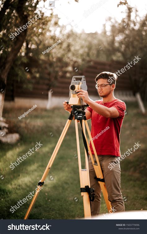 Surveyor Engineer Working Total Station Theodolite