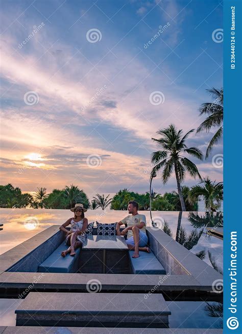 Couple Watching Sunset In Infinity Pool On A Luxury Vacation In Thailand Man And Woman Watching