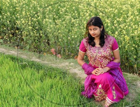 image of a beautiful village girl siting on the land of mustard seed ae864378 picxy