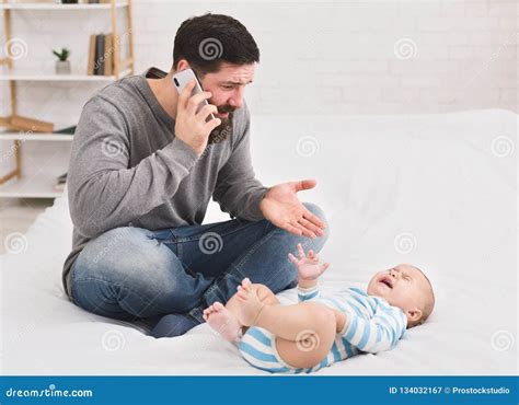 Young Father Frustrated At Crying Baby At Home Stock Image Image Of