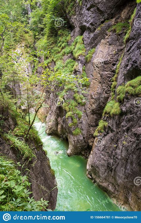 Emerald Or Turquoise Colored Water Of A River In A Gorge In The Alps Of