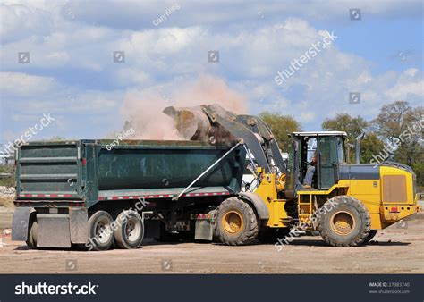 Front End Loader Loading Waste Into A Dump Truck Stock Photo 27383740