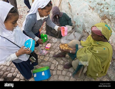 Children Giving Food To A Poor Beggar In The Street Harar