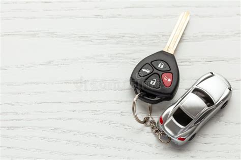 Car Keys With Remote Control Security And Car Key Chain On White Wooden