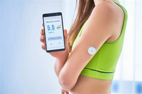 premium photo woman diabetics control and checking glucose level with a remote sensor and
