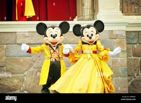 Entertainers Dressed In Mickey Mouse And Minnie Mouse Costumes Perform
