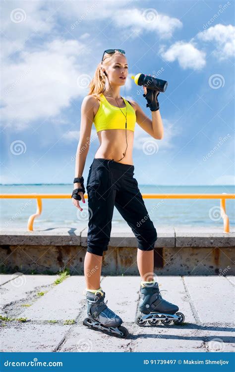 Young Beautiful Sporty And Fit Girl Rollerblading On Inline Sk Stock