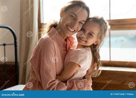 Portrait Of Loving Mom And Little Daughter Hugging Stock Photo Image