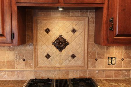 Also note the interest created by the clay tagine lid… Kitchen Tile Work | Backsplash center piece with metal ...
