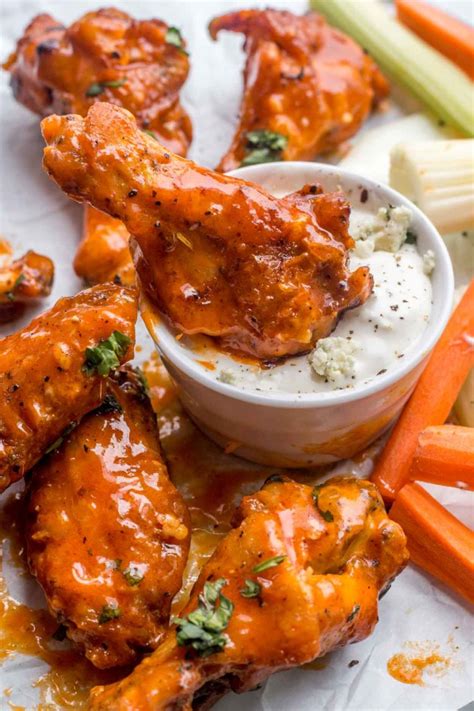 the best recipe for crispy baked chicken wings that are dipped into a mild buffalo wing sauce