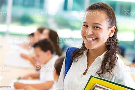 Junior High School Student Smiling In Private School Classroom Stock