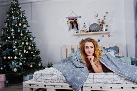 Sexy Naked Blonde Model On Bed With Christmas Gift Boxes Against New