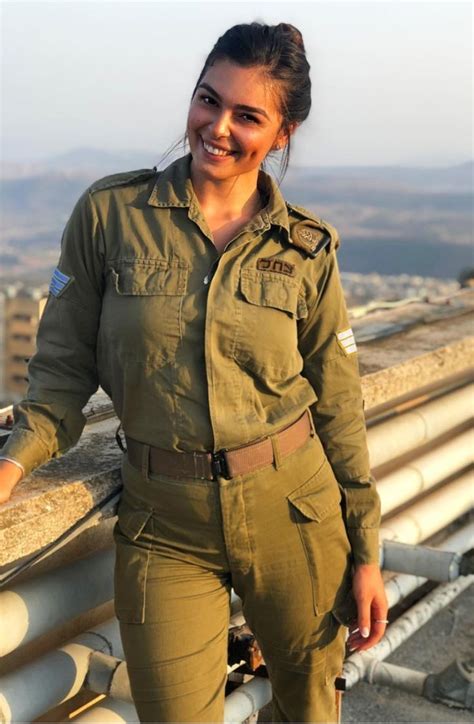A Woman In Uniform Standing On Top Of A Roof