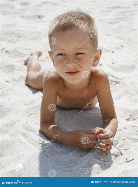 Portrait Of Little Boy Smiling On The Background Of The Sea Beach
