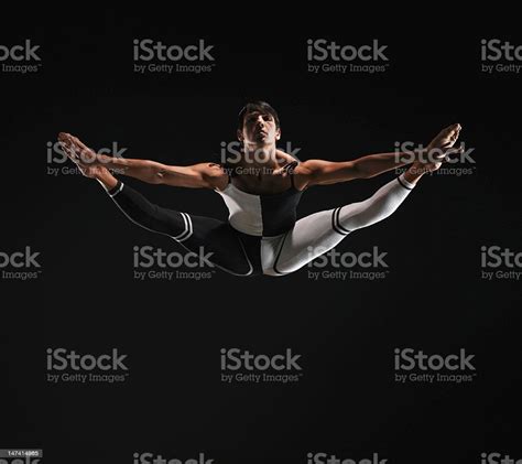 Male Ballet Dancer In Mid Air Splits Toes Pointed Stock Photo