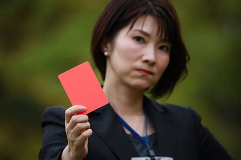 Female Employee Issuing A Red Card Stock Photo Download Image Now