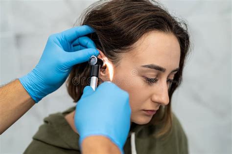 Advanced Examination Of A Womanand X27s Ear Using An Otoscope At A