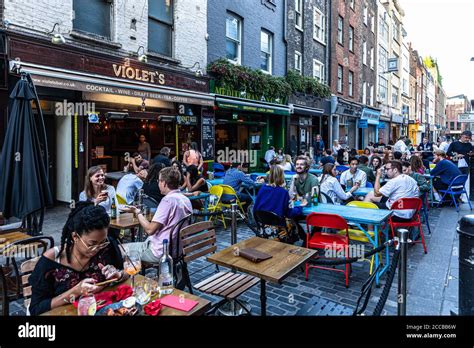 Customers Dining Al Fresco On A Pedestrianised Street Berwick Street Soho London UK Stock