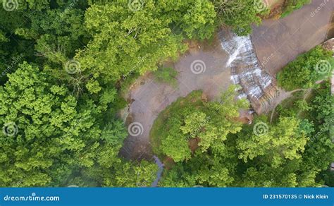 Aerial Looking Down At Cascading Waterfalls In River Surrounded By