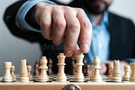Hand Of Businessman Moving Chess Figure In Competition Success Play