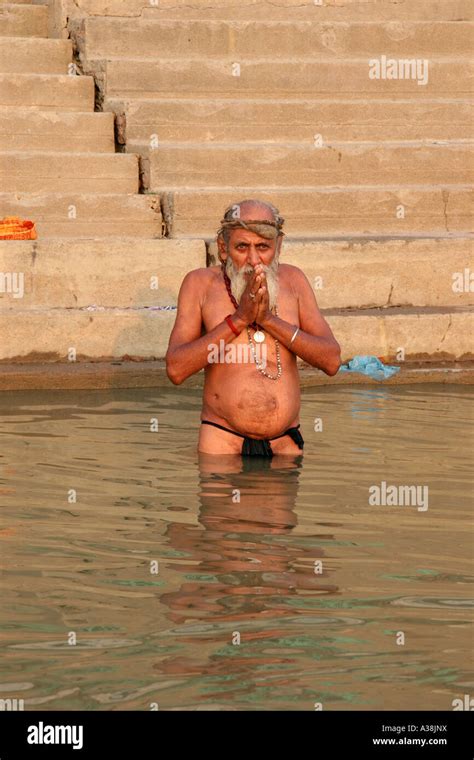 pilgrim praying in the early morning in the river ganges varanasi uttar pradesh india stock