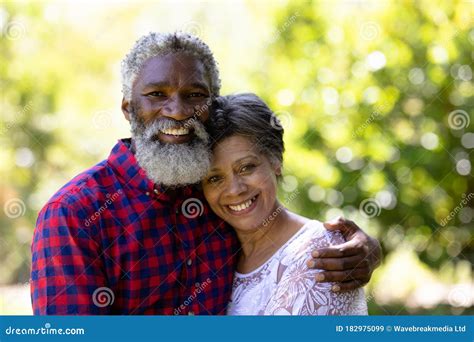 Portrait Of A Senior Mixed Race Couple Enjoying Their Time At The Garden Stock Image Image Of
