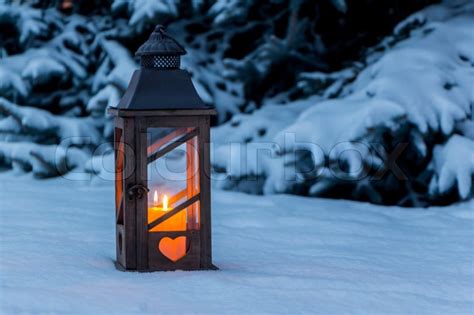 A Lantern Lights Up In The Snow At Stock Image Colourbox
