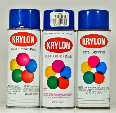Three Cans Of Krylon Paint Sitting Side By Side