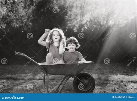 Children Ride In Wheelbarrow Stock Image Image Of Sunset Childhood