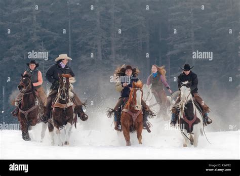 Cowgirls Riding At Full Gallop Toward Camera In Snow Kalispell