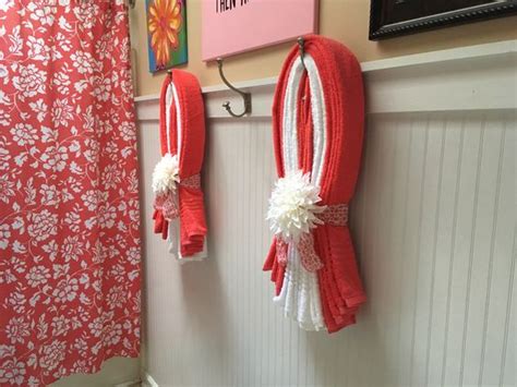 Red towel hangs in a bathroom. 25+ Creatively Easy Decorative Towels For Bathroom Ideas