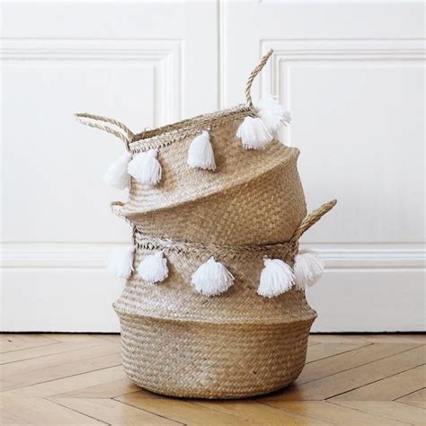 Three Baskets Stacked On Top Of Each Other With Tassels And Pom Poms